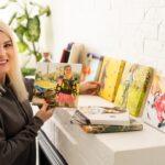 Druk na płótnie. Zdjęcie z galeryjną metodą owijania płótna naciągniętego na blejtram. Kobieta wisi kolorową fotografię podróżniczą