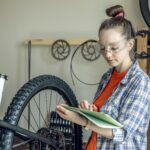 Woman fixing a mountain bike in a repair shop