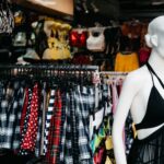 Vibrant market scene with a showcase of trendy clothing and a mannequin in an outdoor retail setting.
